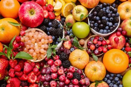 Colorful fruits on a wooden table, showcasing healthy options.