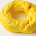 Bright yellow stool on a white background.