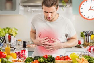 Person in kitchen worried about food poisoning emergency.