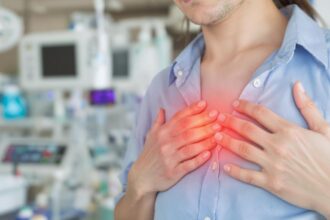 Person with chest pain in a hospital environment.